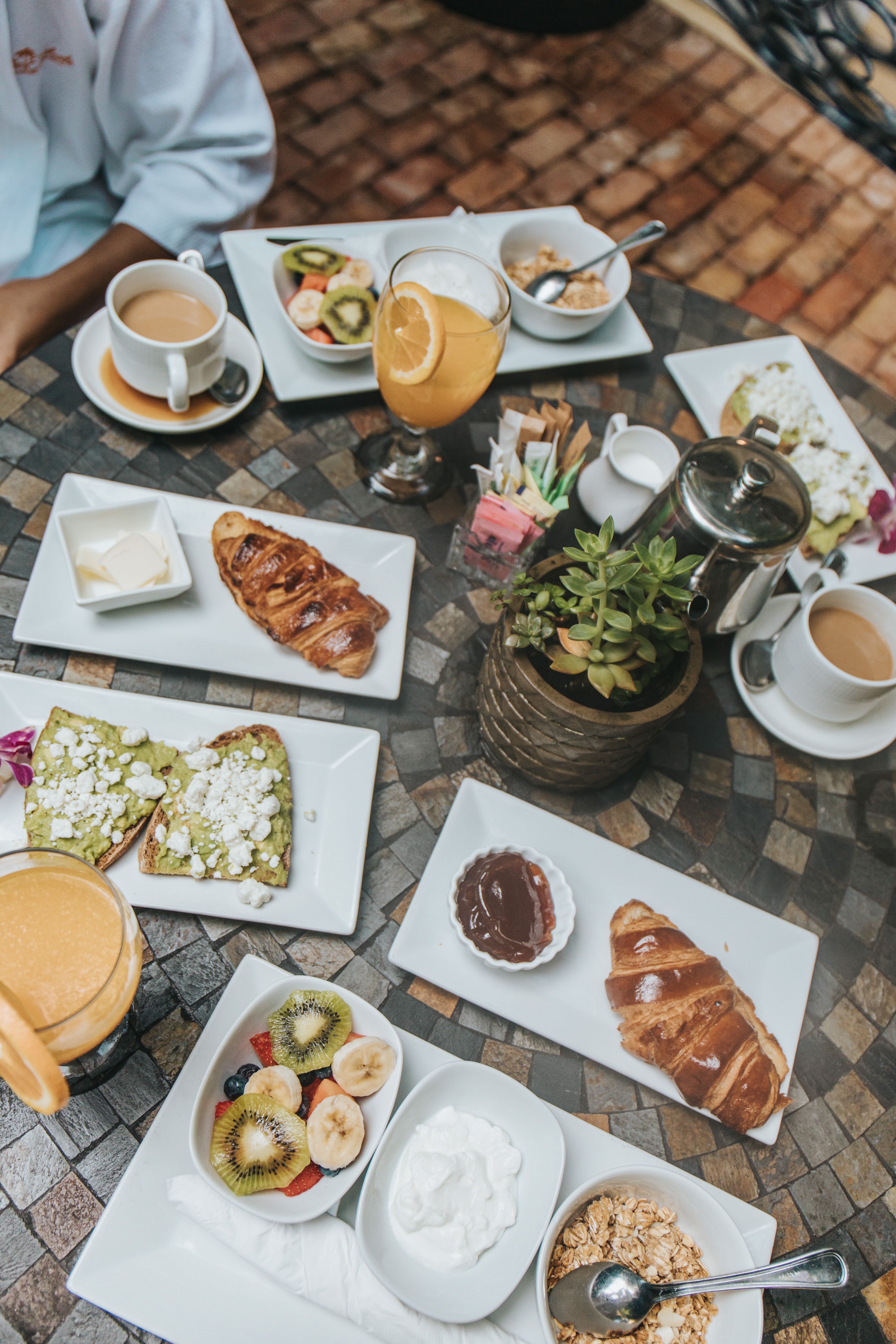 A table set for breakfast with various dishes and drinks.